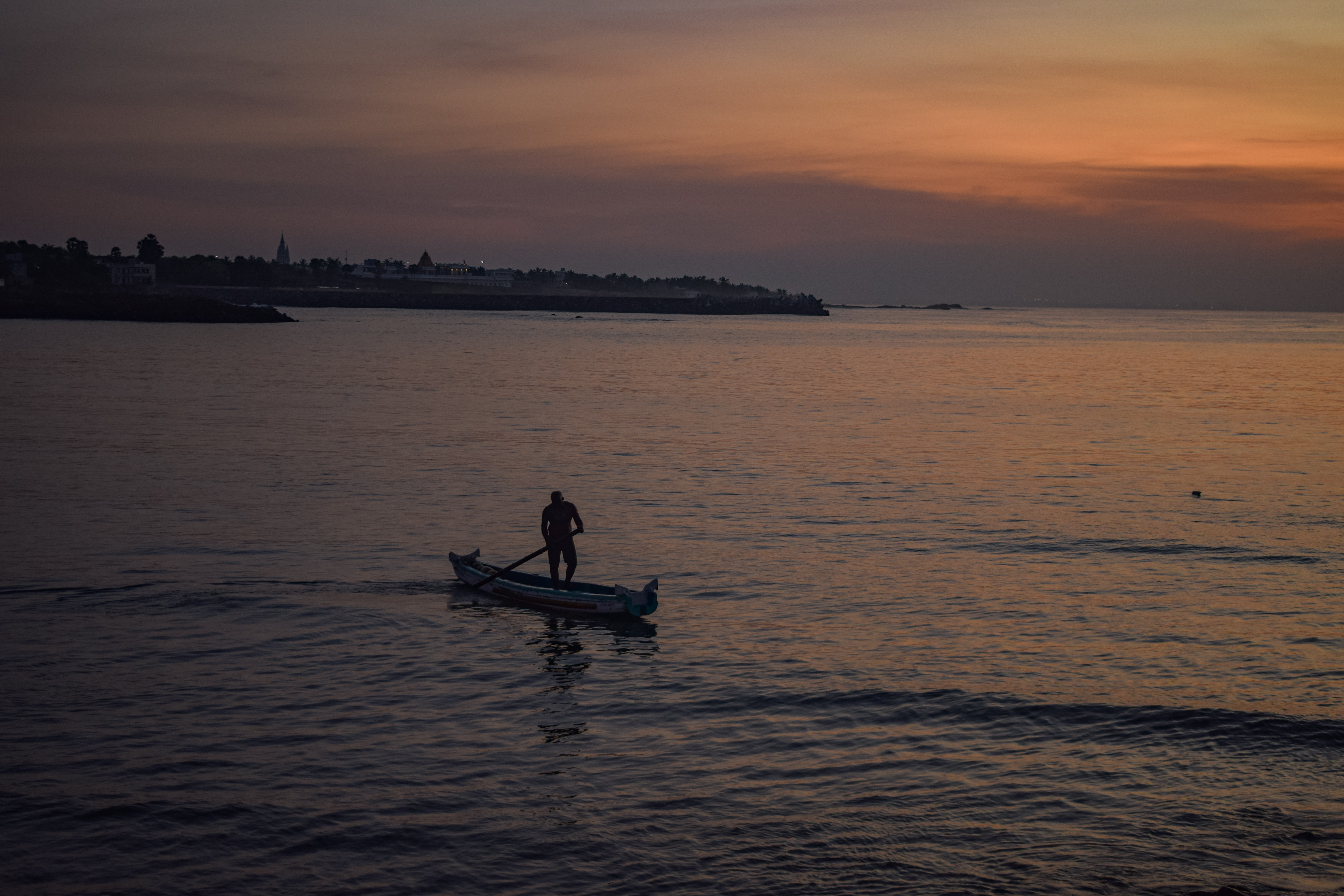 Lonely Fishing Boat at Sunrise – Calm Morning Sea Scene